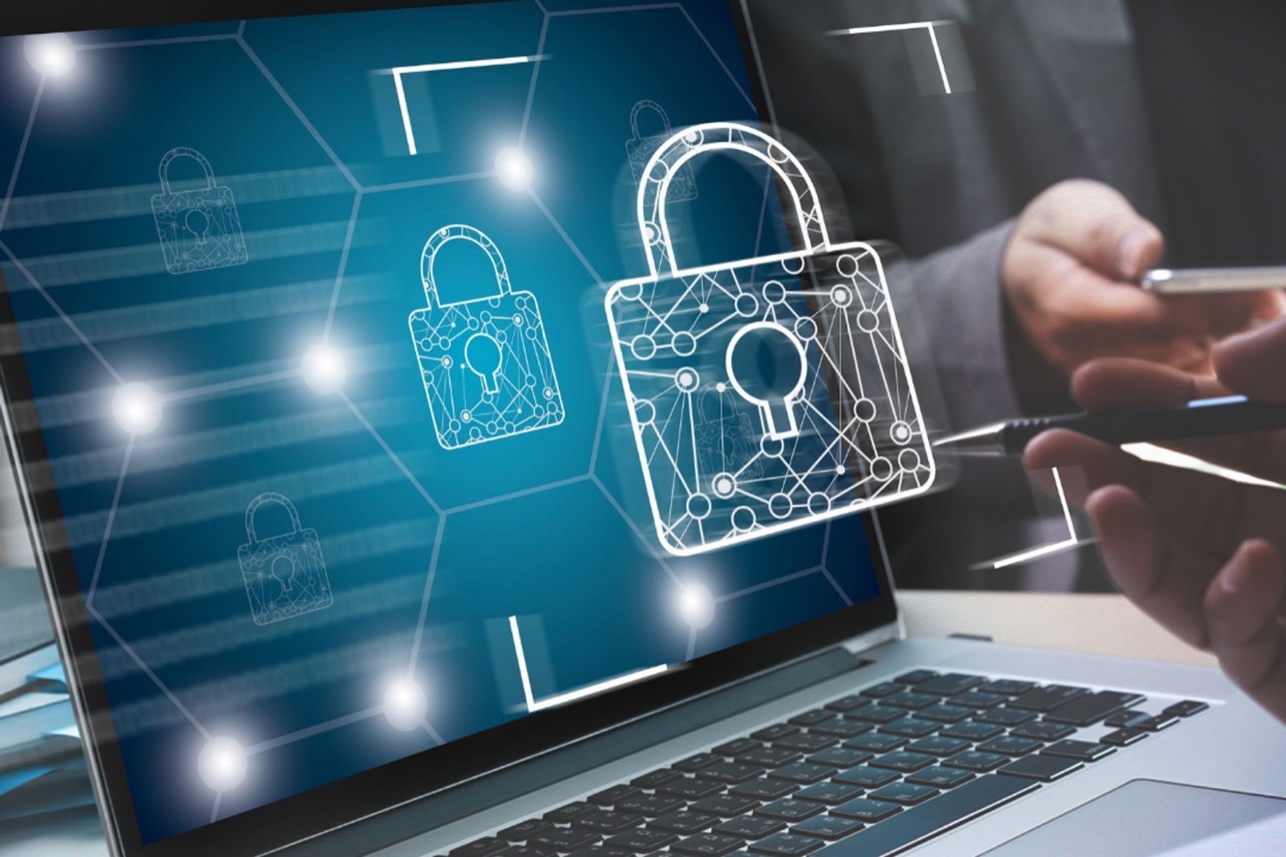 A padlock hologram in front of a laptop, representing cyber security